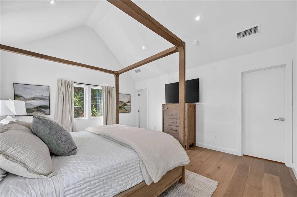 835 Nomas Street, Dallas, TX 75212 Primary Bedroom with Coffered Ceiling and Wood BeamsThis spacious primary bedroom showcases architectural elegance with a coffered ceiling accented by rich wood beams