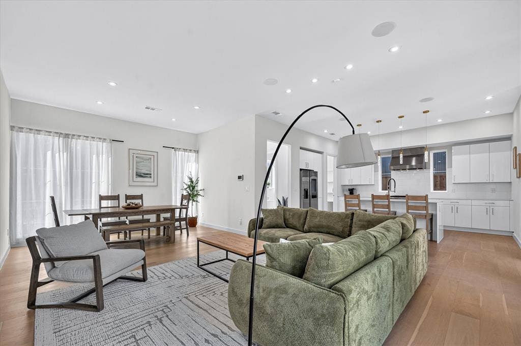 835 Nomas Street, Dallas, TX 75212 Open-concept living area with wood-finish flooring, recessed lighting, and large windows