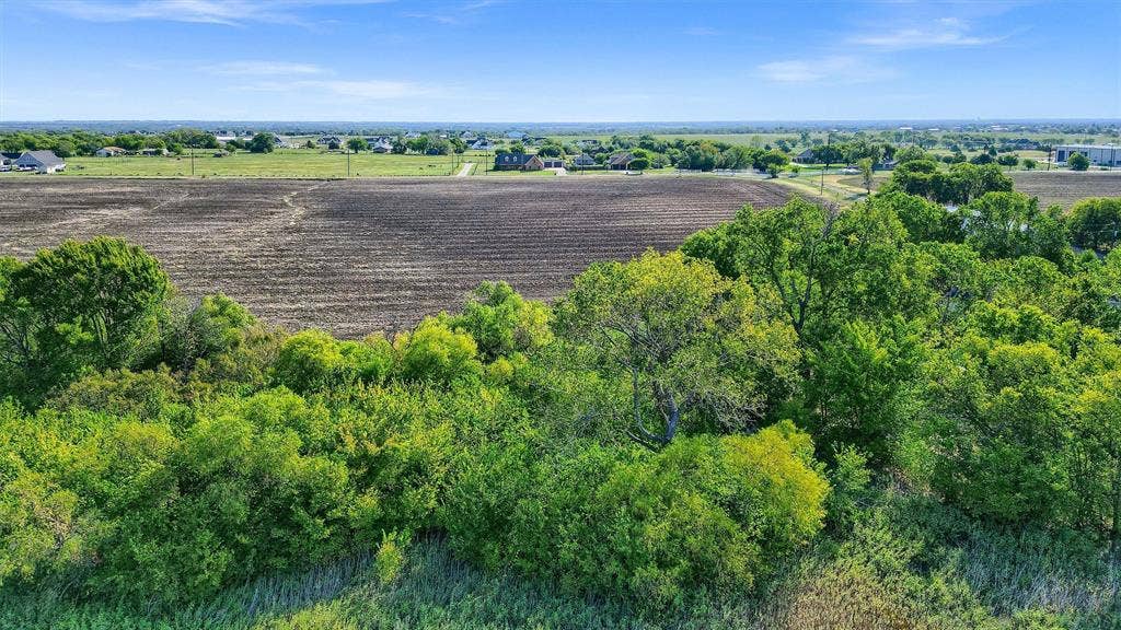 Expansive undeveloped land featuring mature trees and open fields