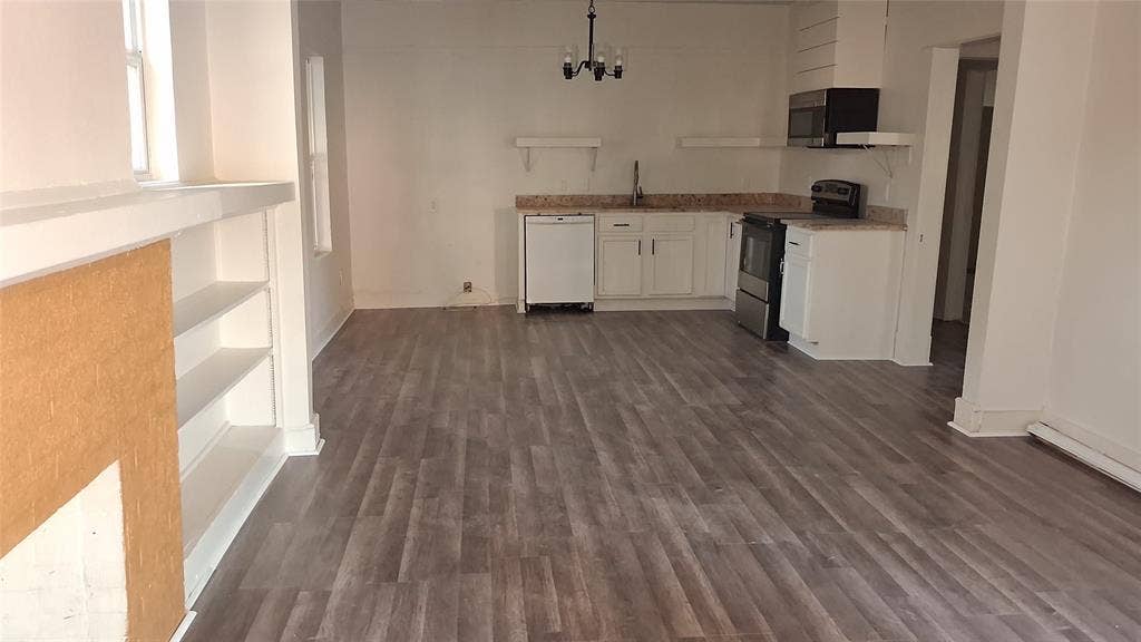 1224 Frost Avenue, Waco, TX 76708 Wood-finish flooring, built-in shelving, white cabinetry, granite-finish countertops, and integrated kitchen appliances