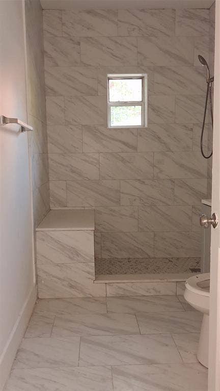 1224 Frost Avenue, Waco, TX 76708 Tiled shower with a built-in bench, handheld shower fixture, and a window for natural light