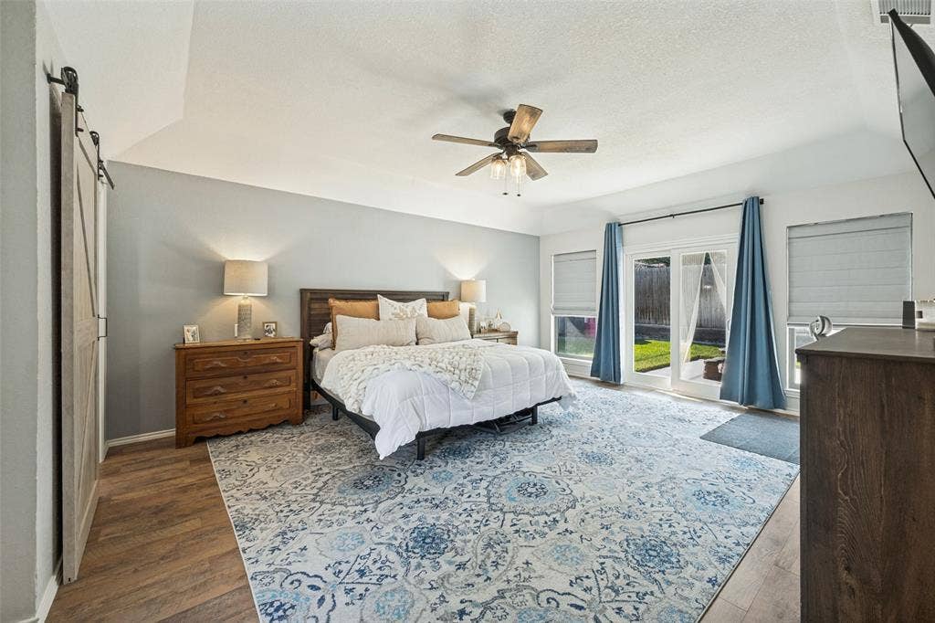 Very Spacious Primary Bedroom with Laminate Wood Flooring