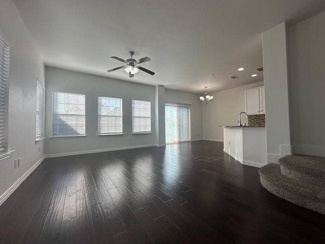 901 Brookville Court, Plano, TX 75074 Spacious open-concept living area featuring wood-finish flooring, multiple windows with blinds, and a ceiling fan