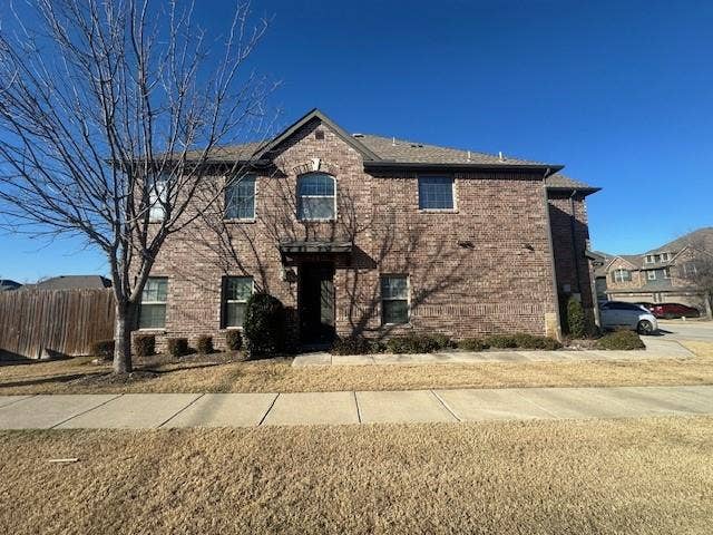 901 Brookville Court, Plano, TX 75074 Brick exterior with complementary stone accents, covered entry, multiple window styles, and a gabled roofline