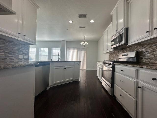 901 Brookville Court, Plano, TX 75074 Kitchen featuring white cabinetry, stone countertops, stainless steel appliances, a mosaic tile backsplash, and dark wood-finish flooring