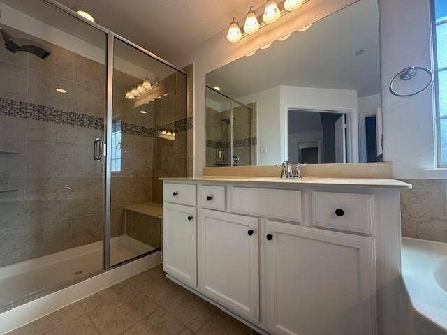 901 Brookville Court, Plano, TX 75074 Glass-enclosed shower with a tiled bench and mosaic accent band