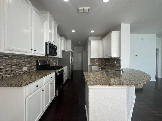 901 Brookville Court, Plano, TX 75074 Kitchen featuring white cabinetry, granite countertops, tile backsplash, and dark wood-finish flooring