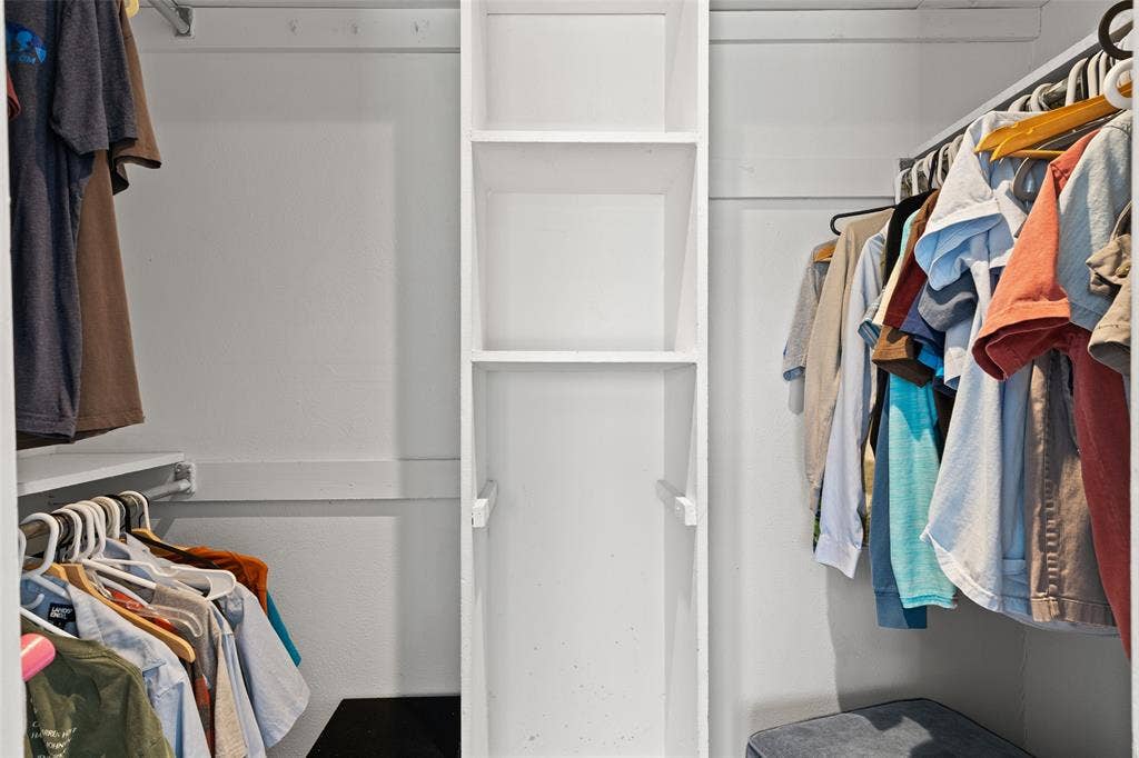 841 Villa Ridge Drive, Garland, TX 75043 Built-in shelving unit with multiple compartments, dual clothing rods, and white painted finishes