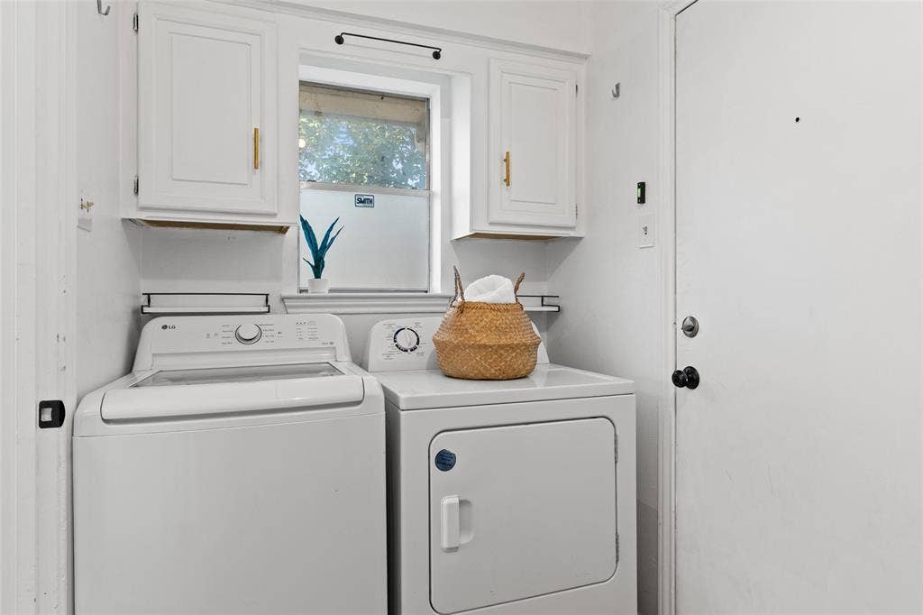 841 Villa Ridge Drive, Garland, TX 75043 White painted cabinetry with gold-tone hardware, a window offering natural light, and a white entry door with a black knob