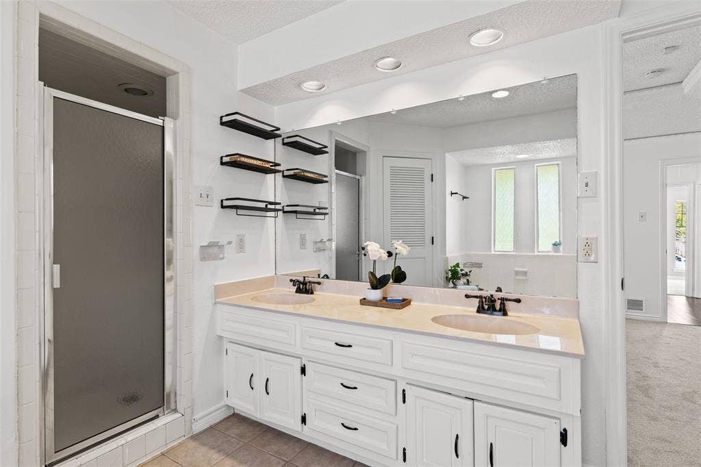 841 Villa Ridge Drive, Garland, TX 75043 Dual vanity with integrated sinks, recessed lighting, expansive wall mirror, and built-in shelving