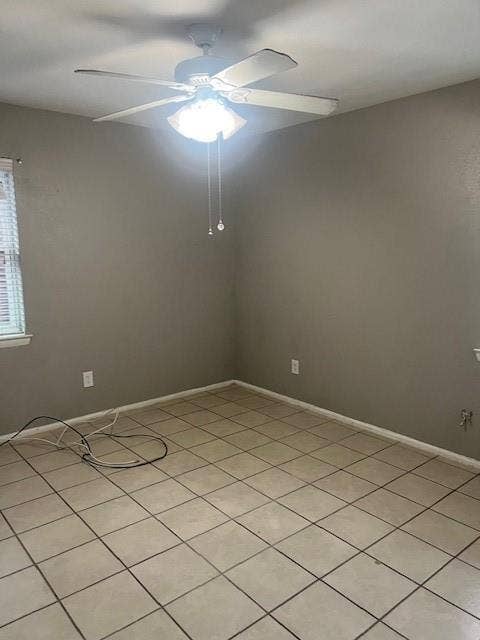 Neutral wall color, ceramic tile flooring, ceiling fan with integrated lighting, window with blinds