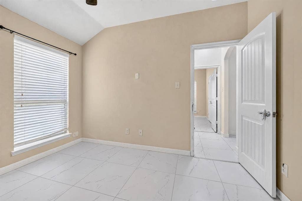 1048 Mercury Drive, Lavon, TX 75166 Vaulted ceiling, white tiled flooring, arched doorway, panel doors, and window with blinds