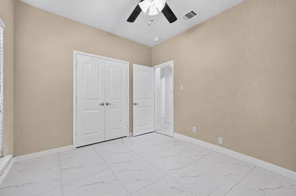 1048 Mercury Drive, Lavon, TX 75166 White tile flooring, double panel doors, white trim, ceiling-mounted fan, and recessed lighting