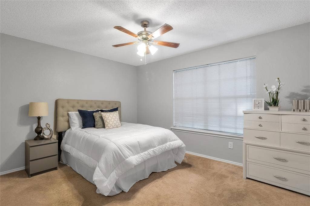 4523 Wescott Drive, Grand Prairie, TX 75052 Bedroom with a ceiling fan, window with blinds, and neutral-toned wall paint