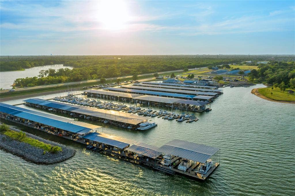 4523 Wescott Drive, Grand Prairie, TX 75052 Marina with covered boat slips, surrounded by a body of water and lush green landscape