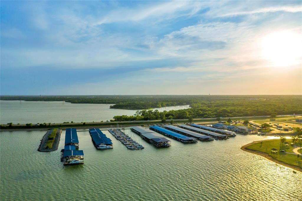 4523 Wescott Drive, Grand Prairie, TX 75052 Marina with numerous covered boat slips, expansive open water, and surrounding green spaces