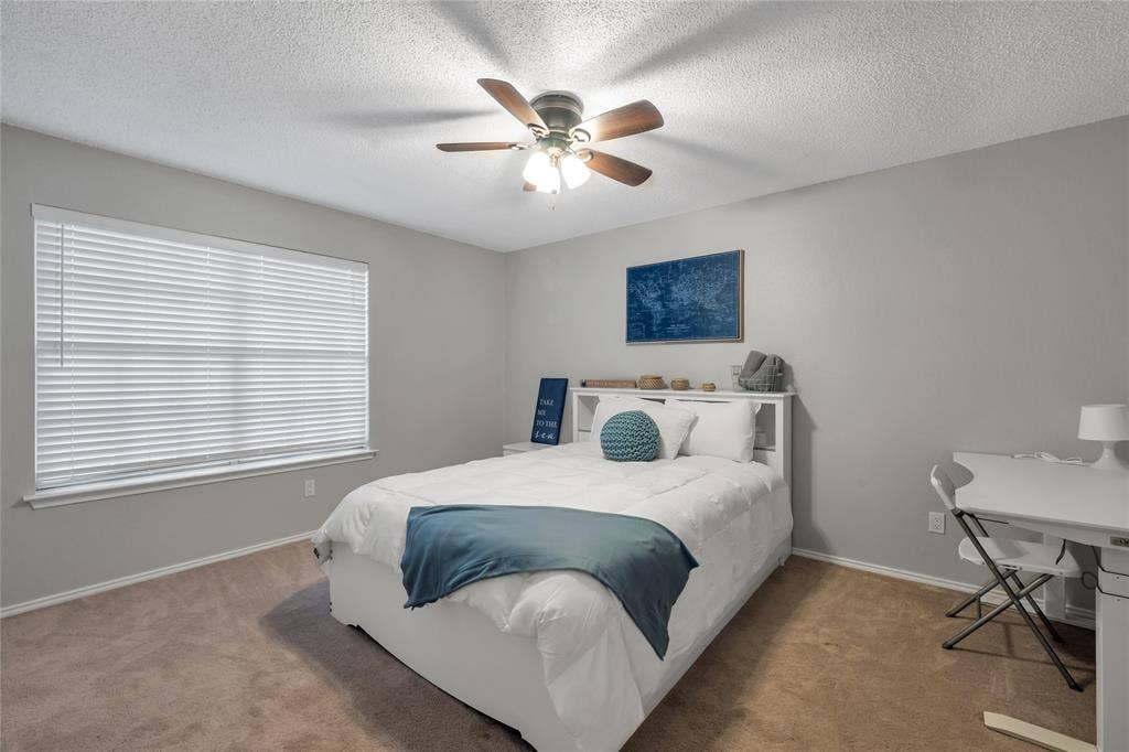 4523 Wescott Drive, Grand Prairie, TX 75052 Carpeted flooring, window with blinds, ceiling fan with light fixture, light gray wall paint, white trim