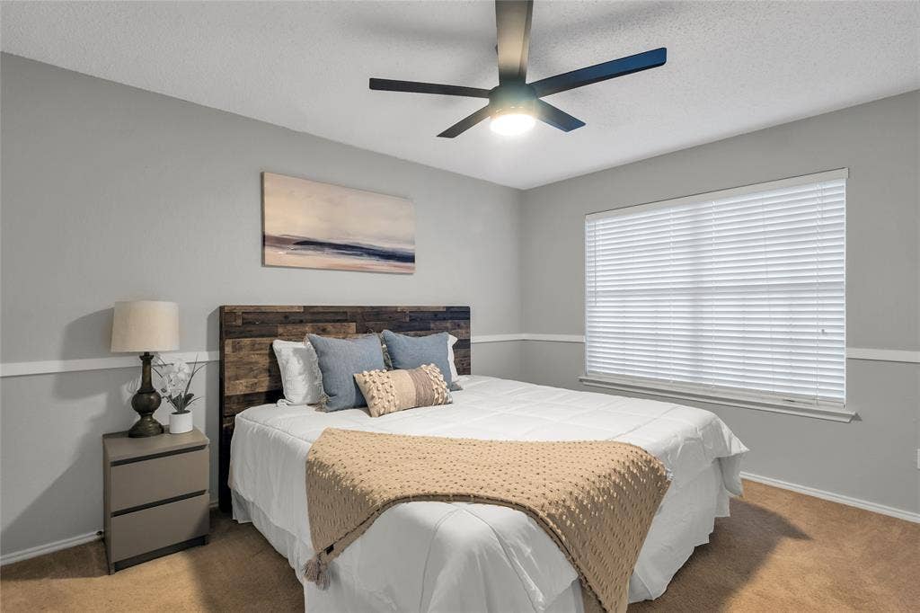 4523 Wescott Drive, Grand Prairie, TX 75052 Recessed window with horizontal blinds, wood-finish headboard, and a ceiling fan with integrated lighting