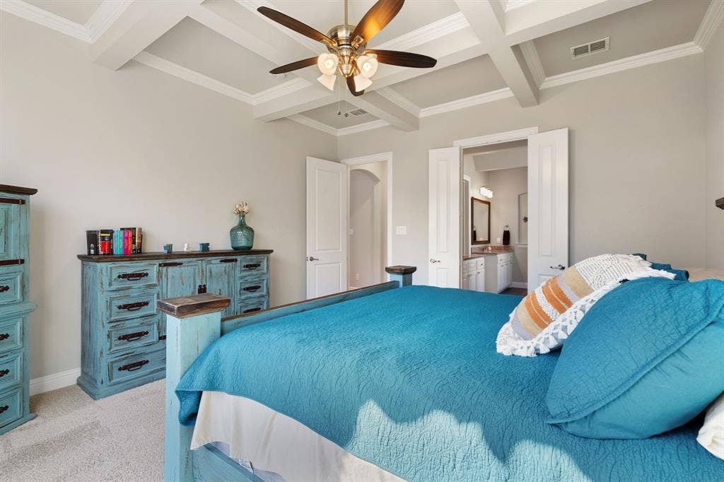 Coffered ceiling with a ceiling fan, light gray wall paint, and white trim