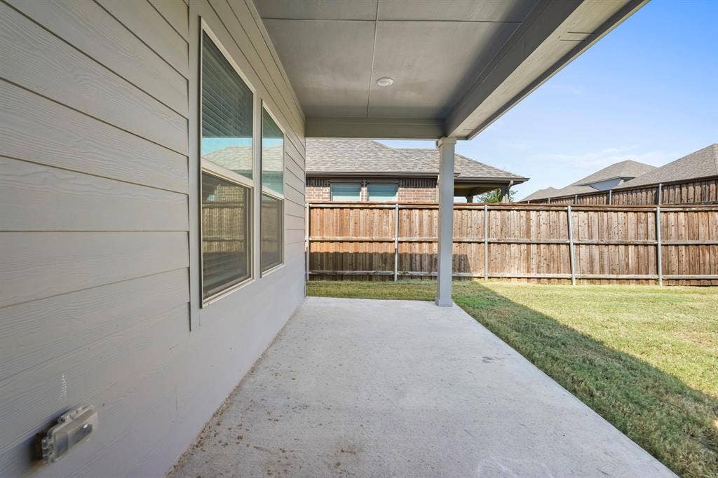 Covered patio with a concrete surface, siding exterior, and a privacy fence