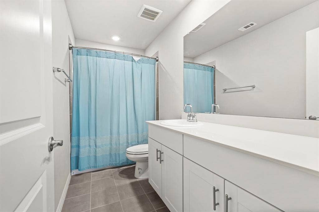 White single-sink vanity with white countertop, chrome faucet, and under-sink cabinetry with bar pulls