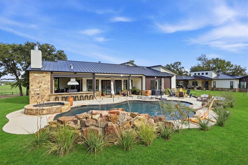 View of hot tub, swimming pool and patio area at rear of the home.  Casita in background.