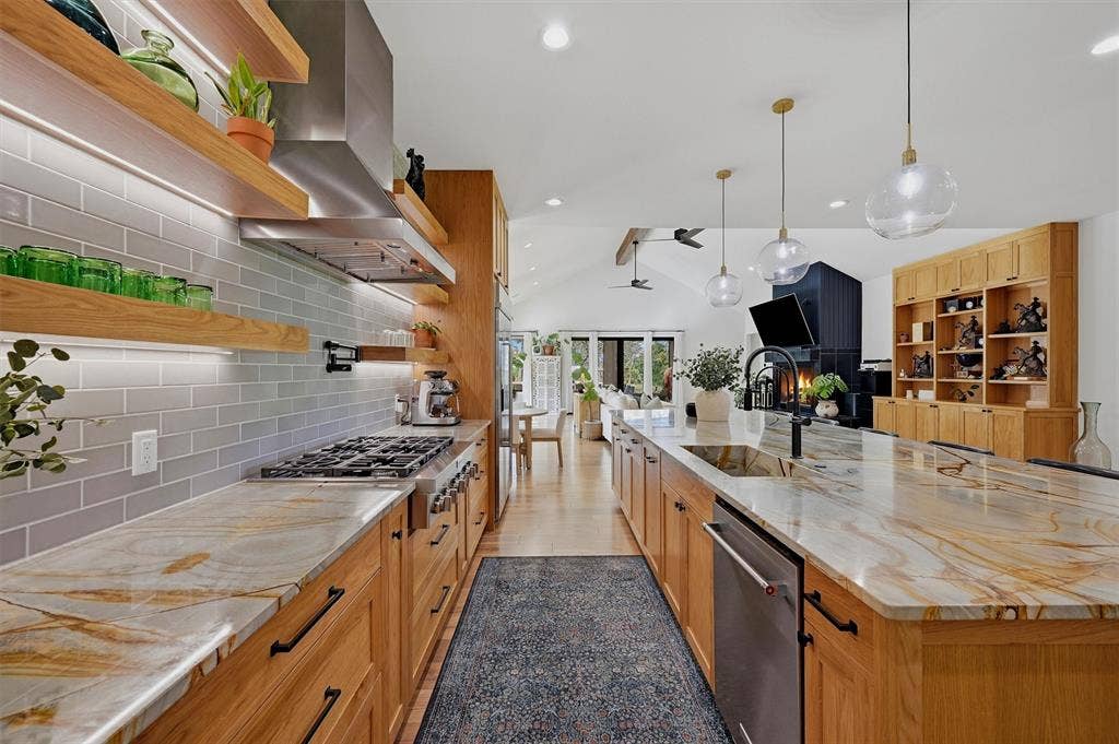Kitchen- 6-burner commercial grade gas stovetop with vent hood.  Integrated farmhouse sink in island