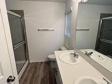 610 Grenada Lake Drive, Princeton, TX 75407 Dual vanity with integrated sinks, chrome fixtures, and a large mirror
