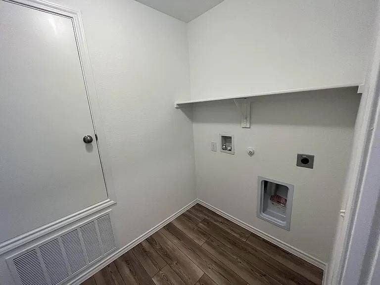 610 Grenada Lake Drive, Princeton, TX 75407 Dedicated utility space with wood-finish flooring, a built-in shelf, and appliance hookups