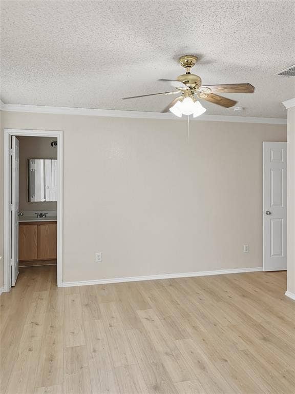 Spacious primary living area featuring wood-finish plank flooring, neutral walls, and abundant natural light