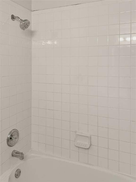 White tiled shower surround with a built-in tub