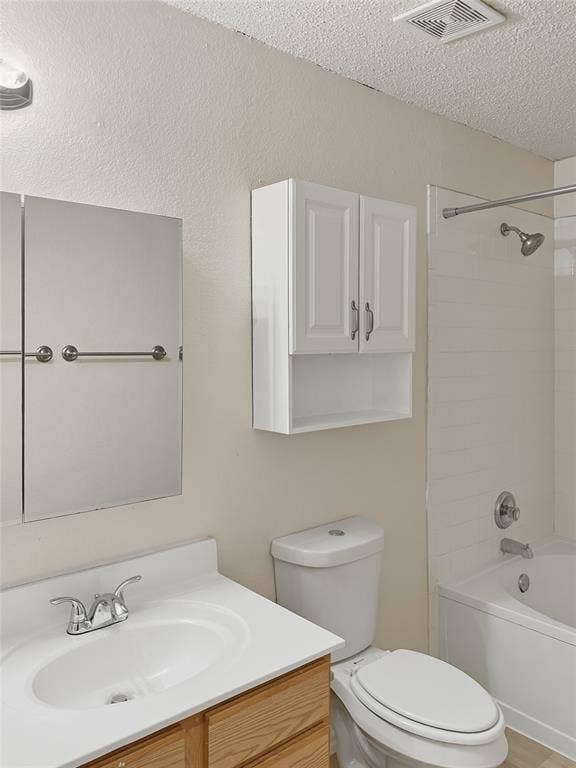 White vanity with a single basin sink, chrome faucet, and wood-finish cabinetry