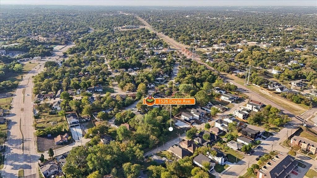 Aerial perspective of a verdant neighborhood with residential properties and arterial roads
