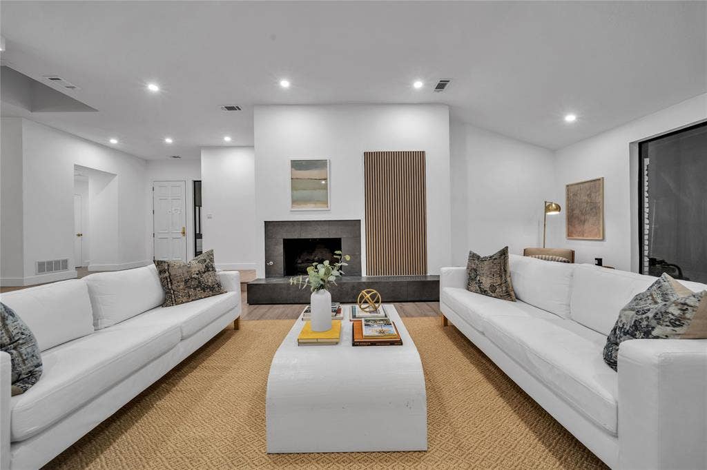 7001 Rocky Top Circle, Dallas, TX 75252 Living room featuring a tile fireplace and light hardwood / wood-style floors