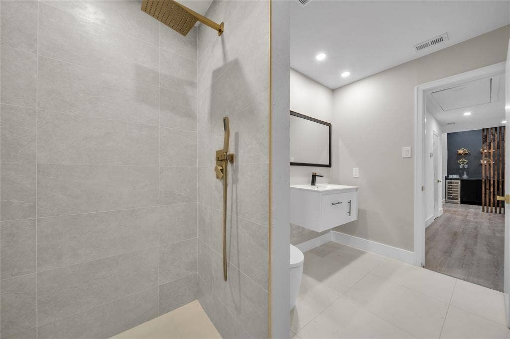 7001 Rocky Top Circle, Dallas, TX 75252 Bathroom with toilet, tile patterned flooring, vanity, and tiled shower