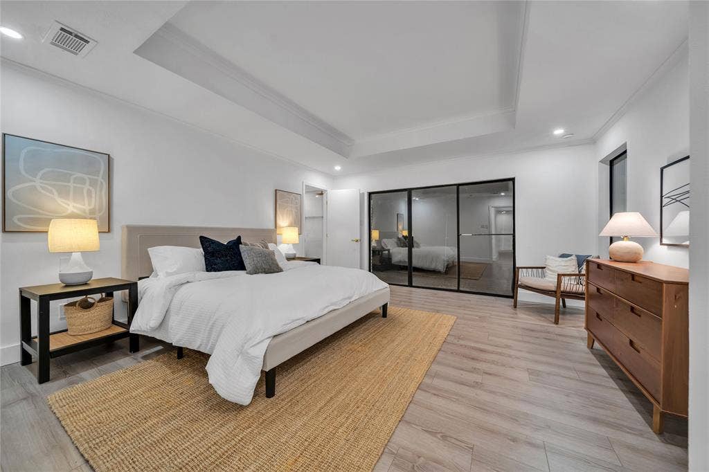 7001 Rocky Top Circle, Dallas, TX 75252 Bedroom with light hardwood / wood-style floors and a raised ceiling