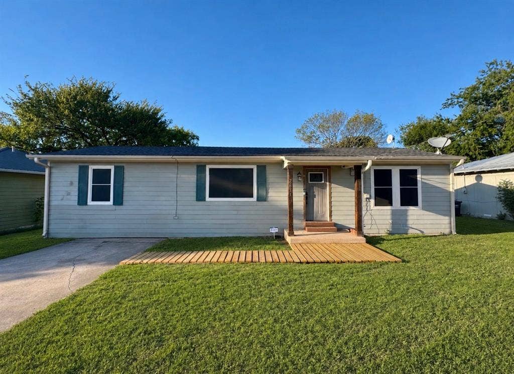 2611 Horne Circle, Caddo Mills, TX 75135 Charming single-story residence featuring cream-colored exterior siding with dark trim, multiple windows for natural light, and a welcoming covered entry
