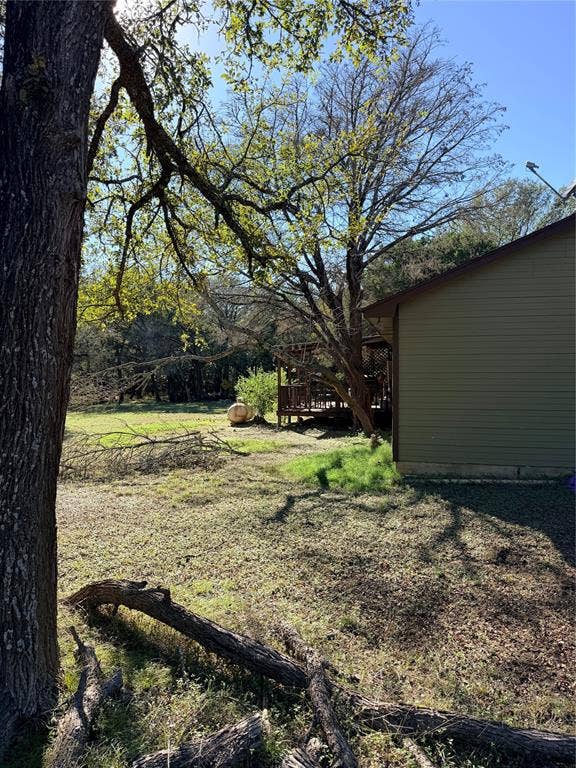 177 Highline Road, Valley Mills, TX 76689 Expansive exterior grounds featuring mature trees and a wood-decked patio
