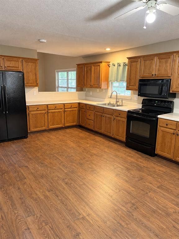 1017 W 3rd Street, Taylor, TX 76574 Expansive kitchen space with vast counter space and built-in microwave and stove range.