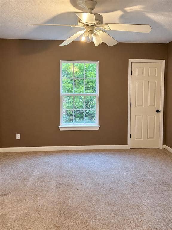 1017 W 3rd Street, Taylor, TX 76574 Well-proportioned bedroom featuring clean finishes and ceiling fan fixture.