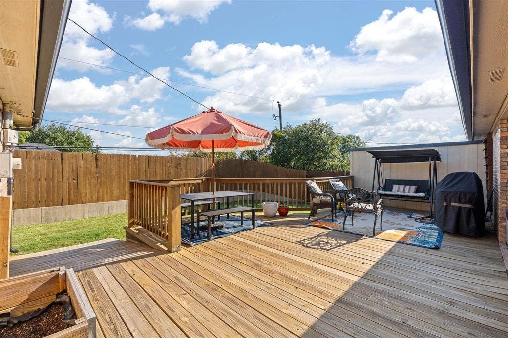 Expansive wooden deck with a built-in railing
