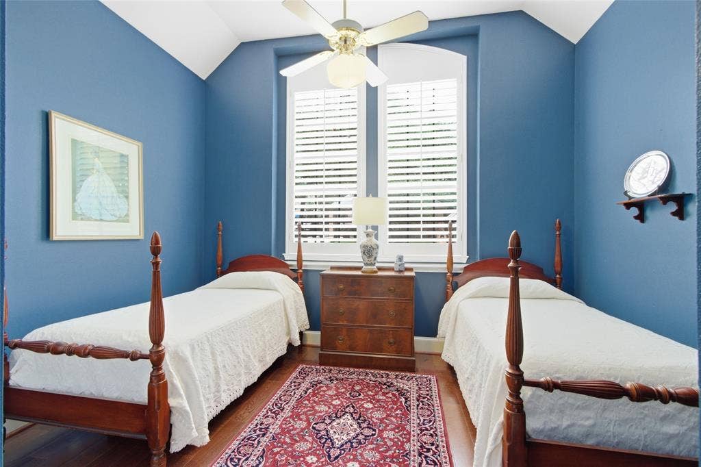 Secondary bedroom with wood floors, tall windows and plantation shutters!