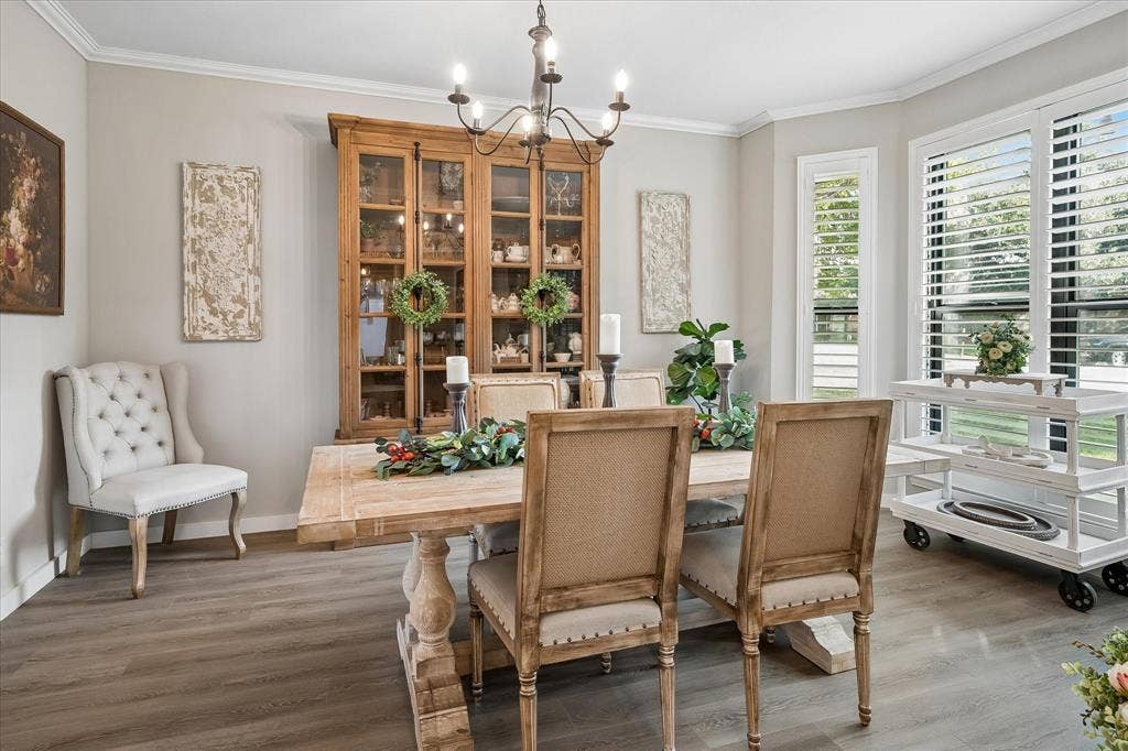 10102 Laingtree Drive, Dallas, TX 75243 Wood-finish flooring, multi-pane windows with adjustable plantation shutters, crown molding, and a wrought-iron style chandelier