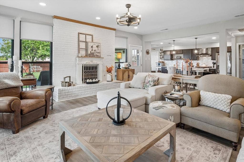 10102 Laingtree Drive, Dallas, TX 75243 Living area featuring a floor-to-ceiling white painted brick fireplace, wood-finish flooring, recessed lighting, and a drum-style ceiling fan