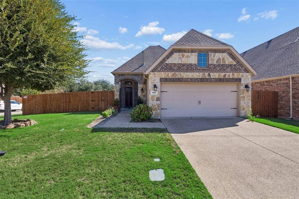 901 Memory Lane, McKinney, TX 75072 Brick and stone exterior with an arched entry into a covered courtyard.