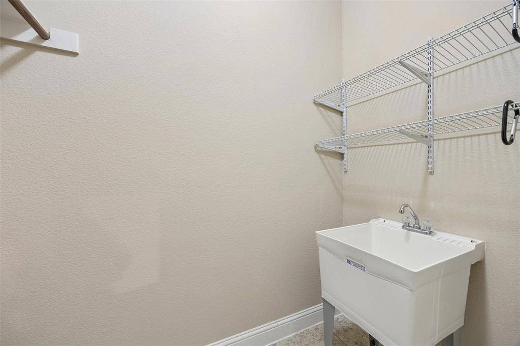 901 Memory Lane, McKinney, TX 75072 Utility sink in Laundry room. *Opposite wall has the space for full washer and dryer and a built in cabinet.