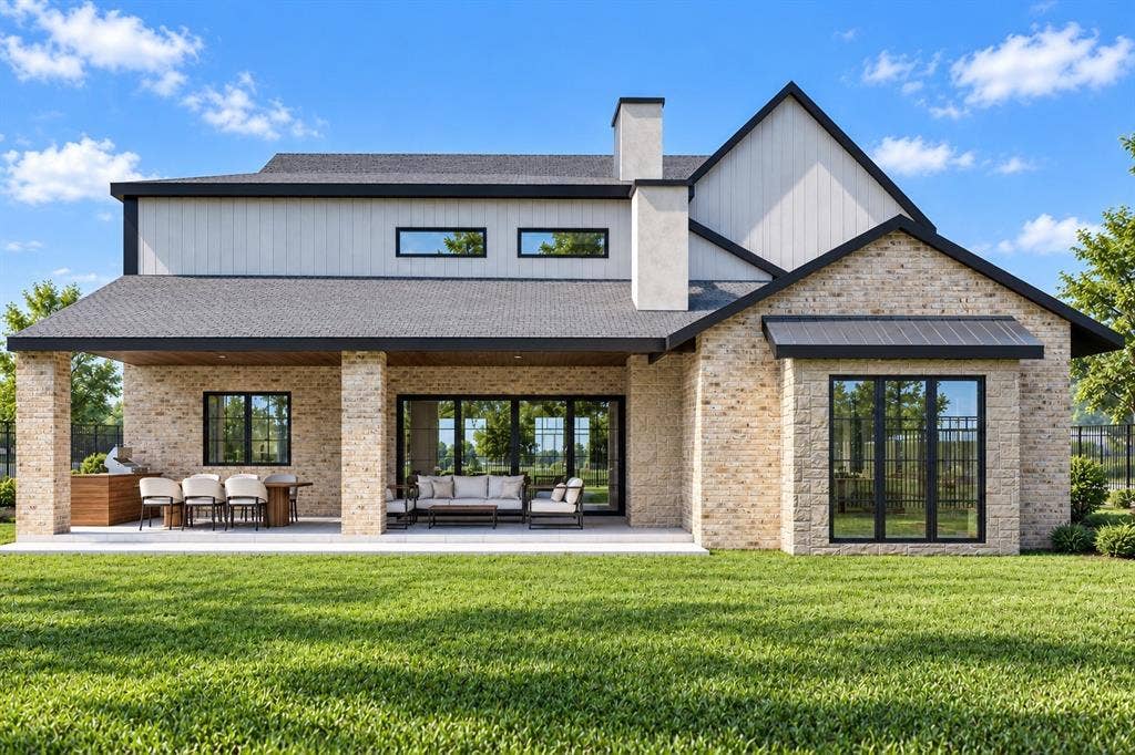 145 Stafford Drive, Heath, TX 75032 Two-story residential exterior featuring light-toned brick masonry, vertical siding, an expansive covered rear patio, a built-in outdoor kitchen, and large-format multi-panel windows