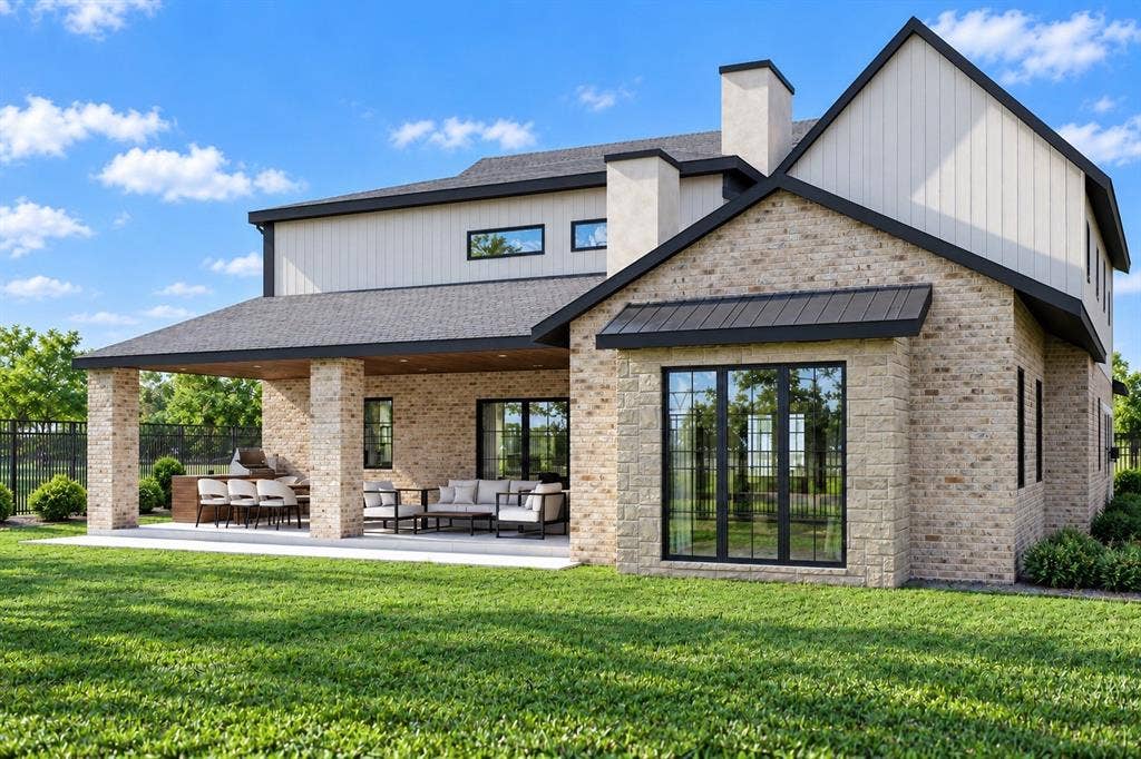145 Stafford Drive, Heath, TX 75032 Rear exterior featuring light-toned masonry, vertical siding, a covered patio with recessed lighting, and built-in masonry grill cabinetry