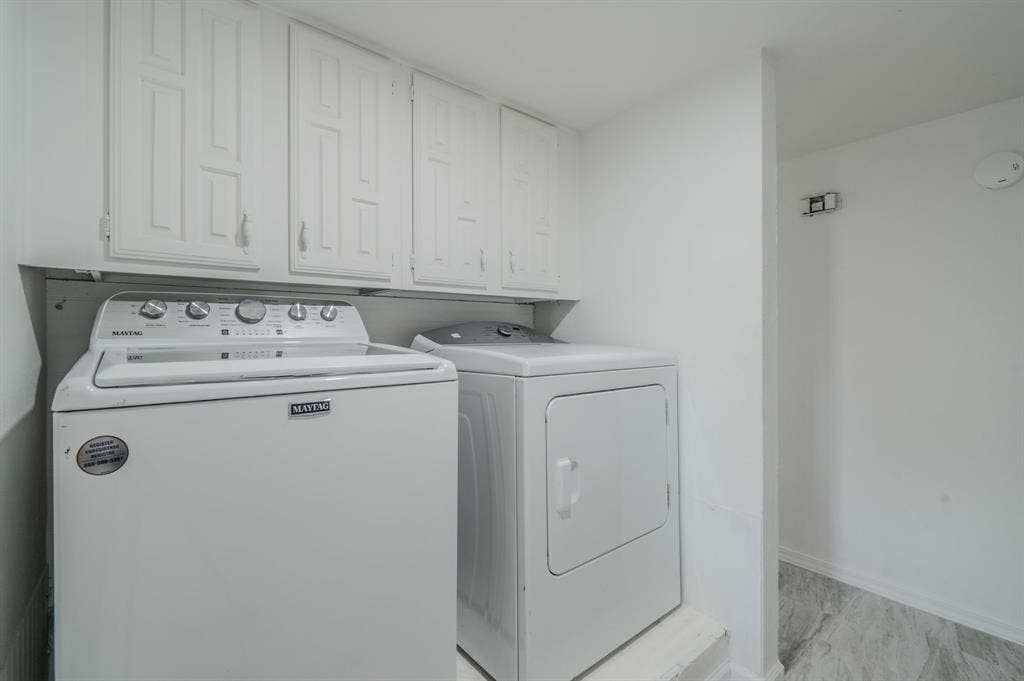 4312 Woodbluff Drive, Mesquite, TX 75150 Laundry area featuring white cabinetry, a built-in shelf, and light-toned flooring