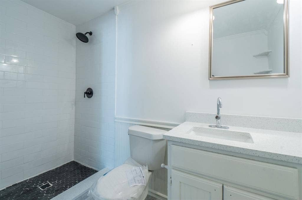 4312 Woodbluff Drive, Mesquite, TX 75150 White subway tile shower surround with black fixtures
